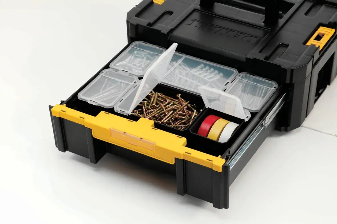 A DEWALT black and yellow tool storage box with opened drawer containing organized compartments with screws, tape, and